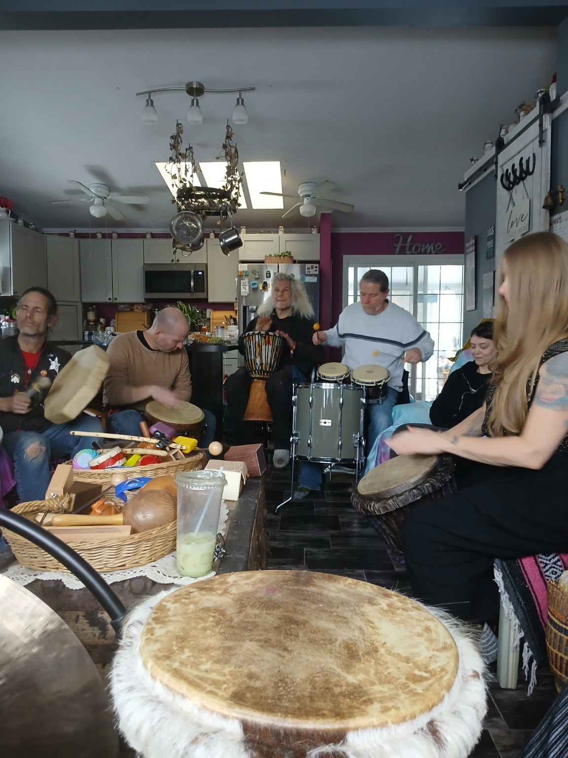 Community drum circle gathering indoors