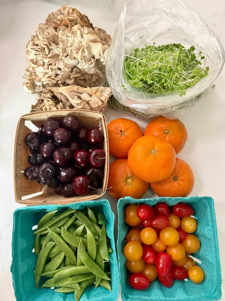 Fresh produce including cherries, citrus, peas, tomatoes, mushrooms and greens