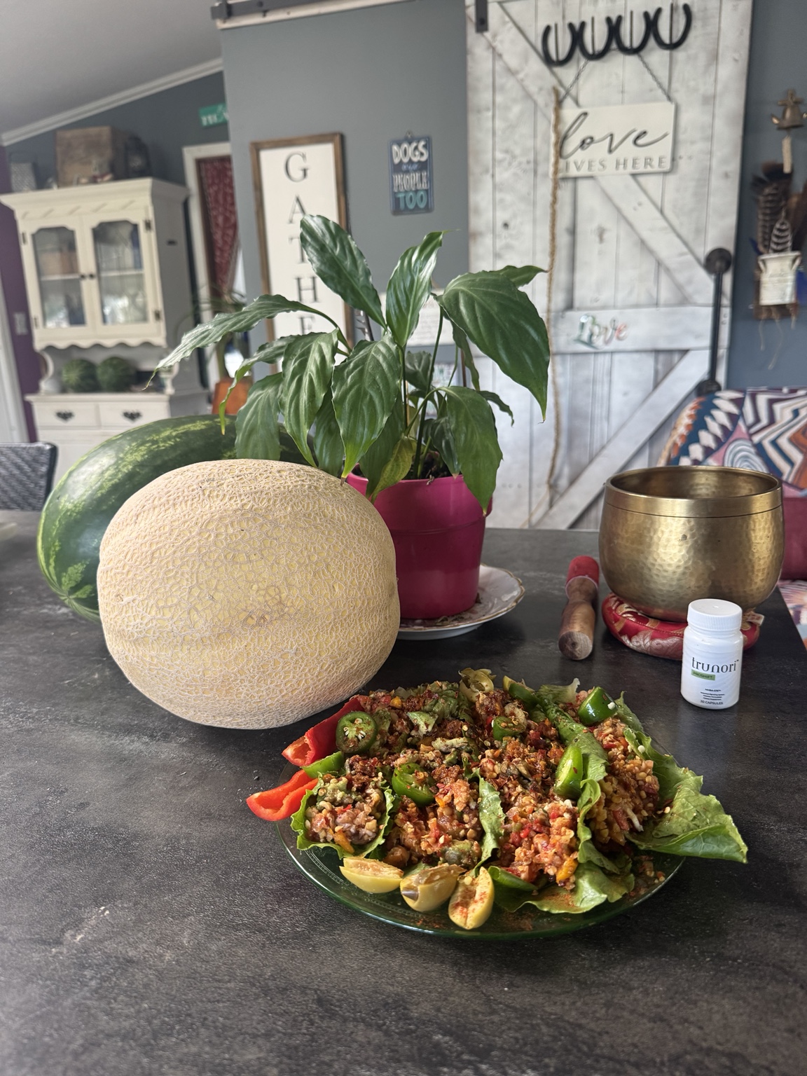 Plant-based salad, fresh melon and singing bowl at Divine Healing Corner