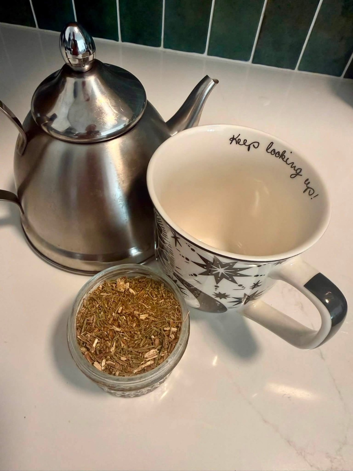 White pine tea beside a teapot